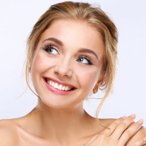 'woman smiling after cosmetic surgery'